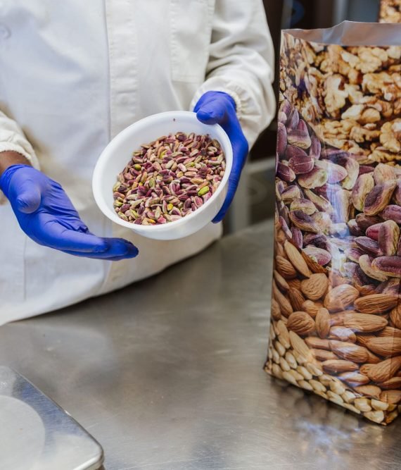 close-up-of-a-bowl-of-dry-pistachios-held-by-worke-2025-07-05-04-53-20-utc (1)